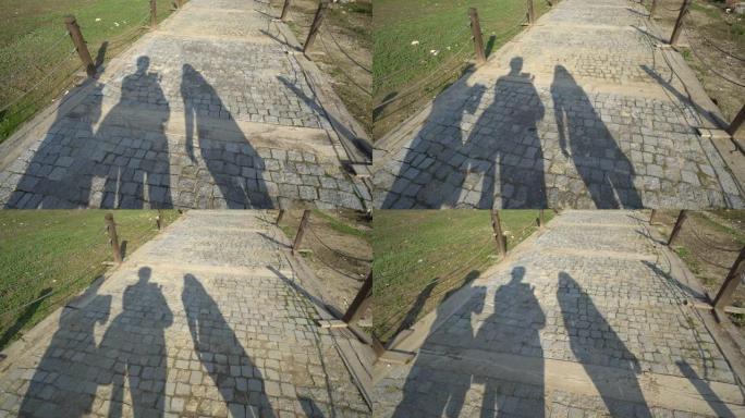 三个人走路的影子。