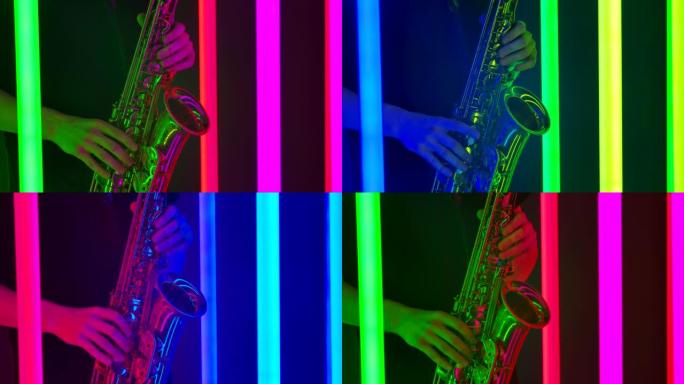 音乐家在萨克斯管上演奏古典旋律的男性手的详细镜头。在黑暗的工作室拍摄，背景为明亮的霓虹灯管。特写。慢