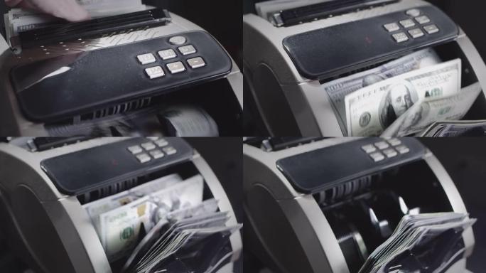 用于纸币计算的货币计数设备。银行金融业务的自动机制。一个人用手把一捆美元放在点钞机里。慢动作。