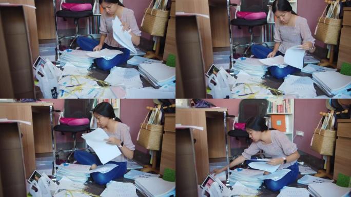 亚洲女性在新年前夕将文件存储在家庭办公室，以便在整洁的工作场所中更好地工作。新家庭办公室setup.