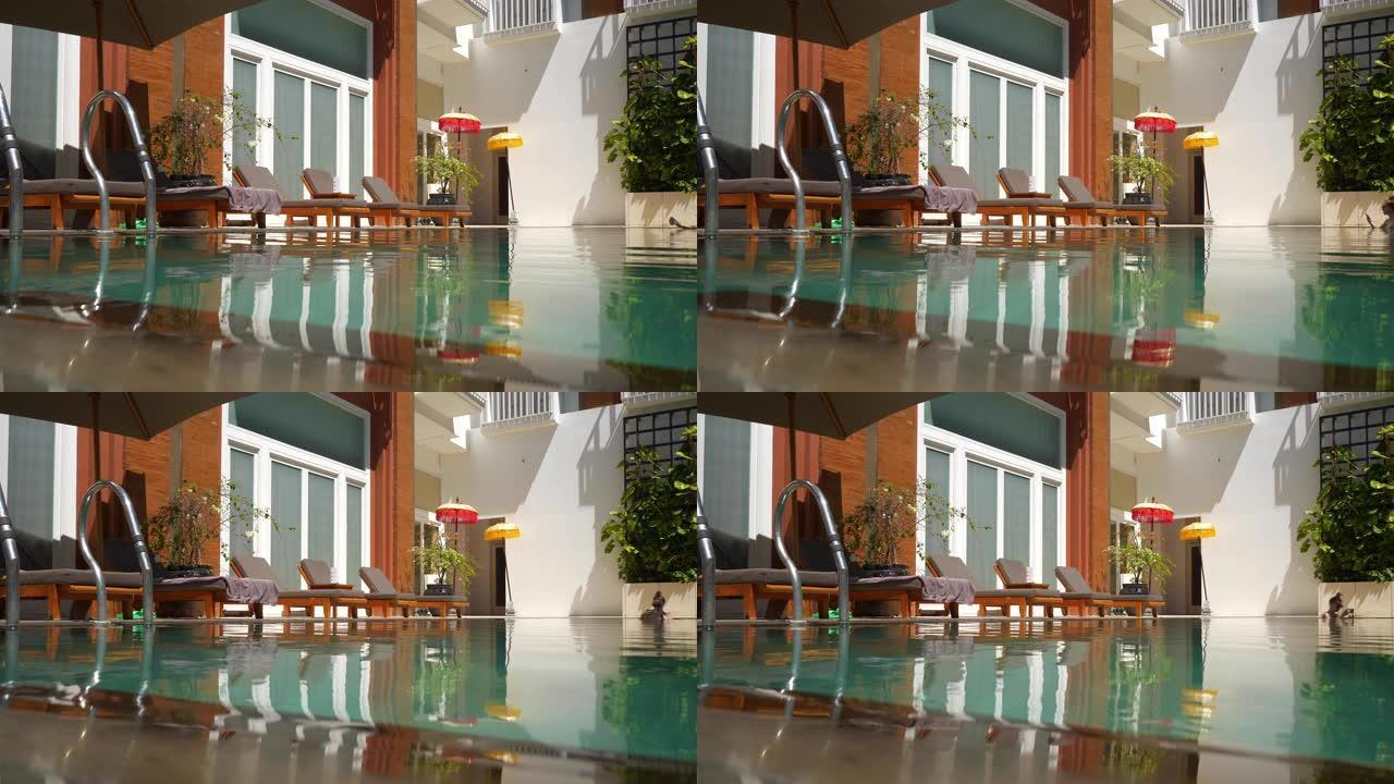 阳光灿烂的巴厘岛豪华酒店游泳池慢动作全景4k印度尼西亚
