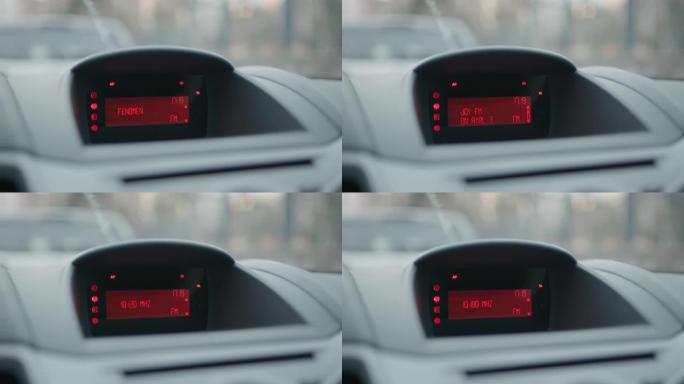 汽车仪表板和红色液晶显示屏，显示时钟并在slowmo中搜索调频广播电台频道