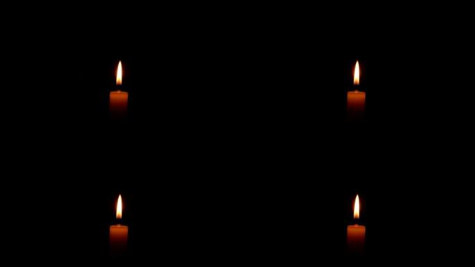 黑暗中燃烧的蜡蜡烛的火焰。蜡烛火的火焰。黑暗中的火。纪念日。沉默一分钟。葬礼服务。阵亡将士纪念日的灾