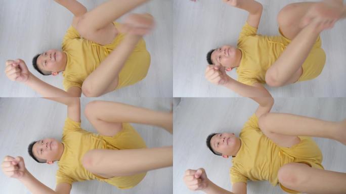 亚洲青春期男孩在家和妹妹做瑜伽，慢动作。