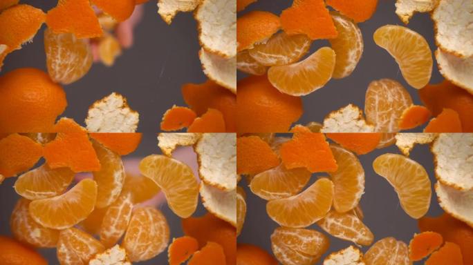 在玻璃背景上的橘子皮背景上落下的普通话切片。底视图。