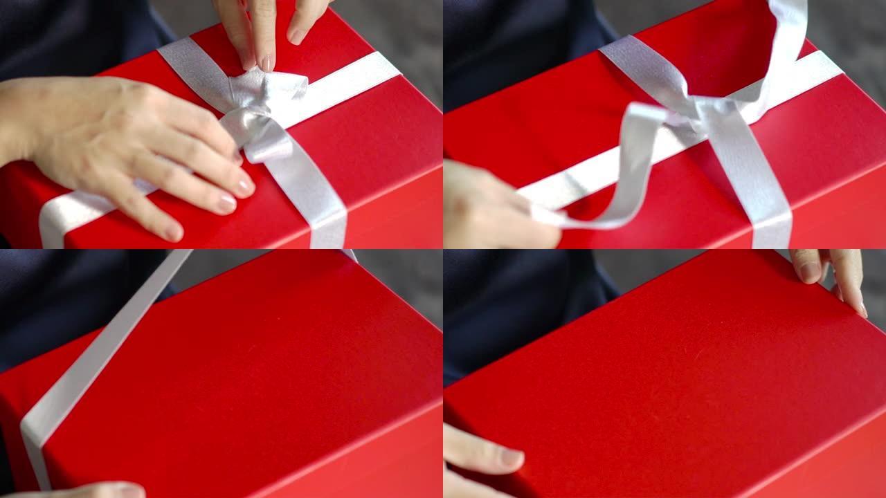 亚洲女人的手打开打开红色礼品盒