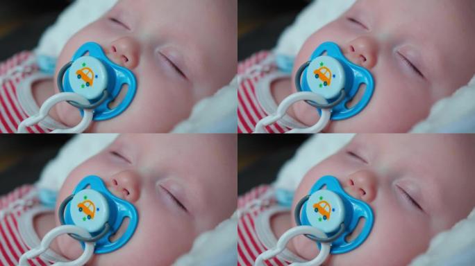 在家用安抚奶嘴睡觉的婴儿肖像。特写镜头。