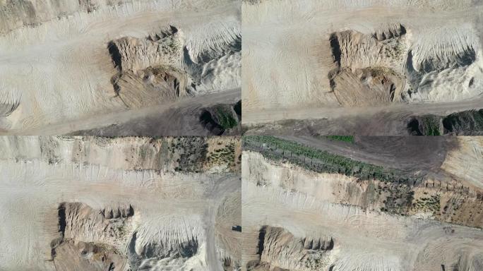 低空飞行在路堤和砾石坑的沙堆上，用无人驾驶飞行器无人机进行航拍