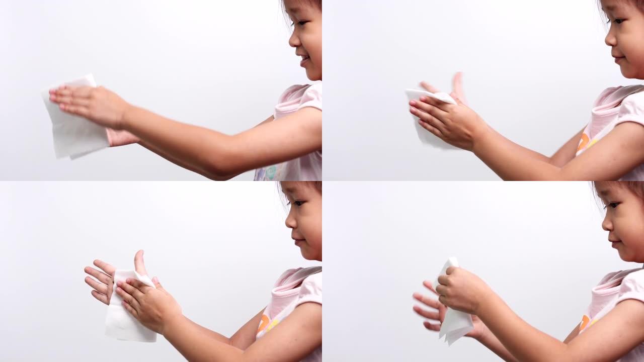 一个亚洲小女孩用白色软组织纸或湿巾清洁双手，以防止冠状病毒新型冠状病毒肺炎病毒感染。医疗保健和医疗概