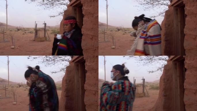 年轻的纳瓦霍人一家人戴着口罩走出霍根，以帮助防止新型冠状病毒肺炎
