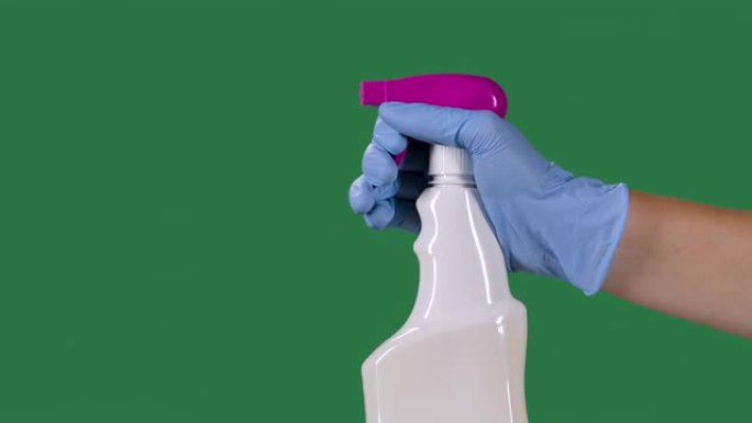 戴着防护手套的人喷洒清洁卫生喷雾剂，用于消毒和预防COVID 19。绿色屏幕，色度键。慢动作。特写