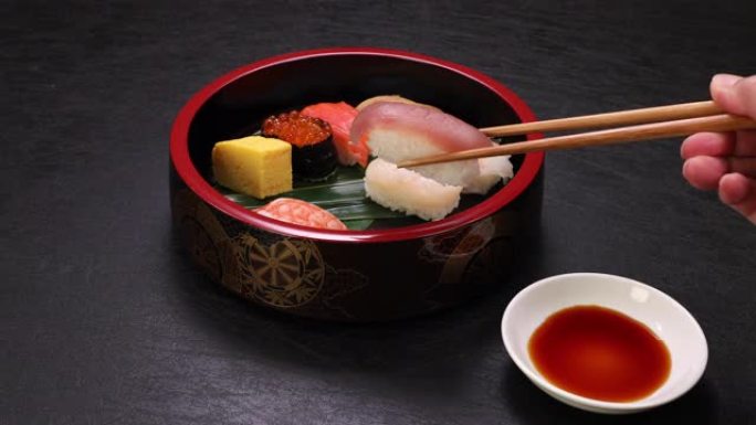 提起寿司的场景，我用筷子将寿司端到寿司盘上。