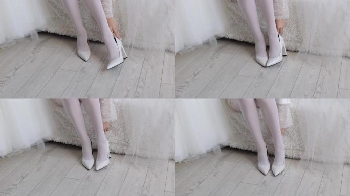 女人穿上婚鞋。新娘鞋，仪式前的晨衣。纤细的腿