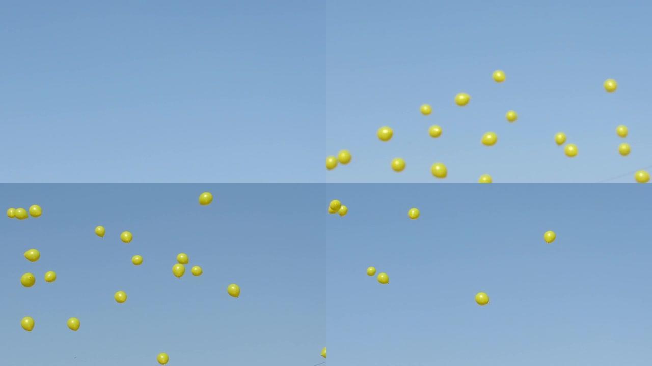明亮的白天拍摄天空中的黄色氦气球。
