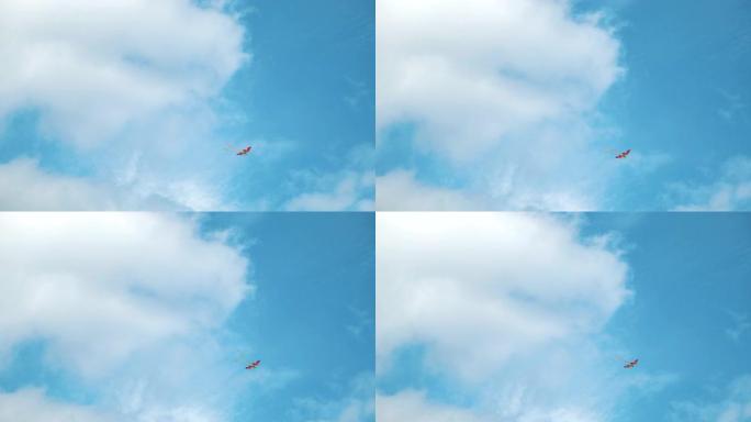 风筝在天空中在云间飞舞。概念。仰视夏天的蓝天白云和飞扬的彩虹彩色风筝，自由和童年的概念。