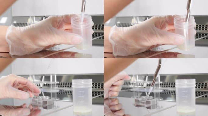 医生处理精液样本的特写。科学家胚胎学家将精子从测试库中分发进行分析。现代微生物学柜的实验室工作人员。