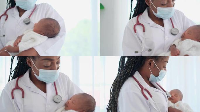 戴着口罩的非裔美国女医生将正在睡觉的新生婴儿抱在胸前，看起来像她唱歌要睡觉的婴儿