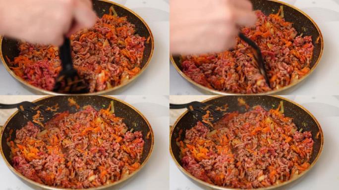 在煎锅里煎肉末、洋葱和胡萝卜。肉酱