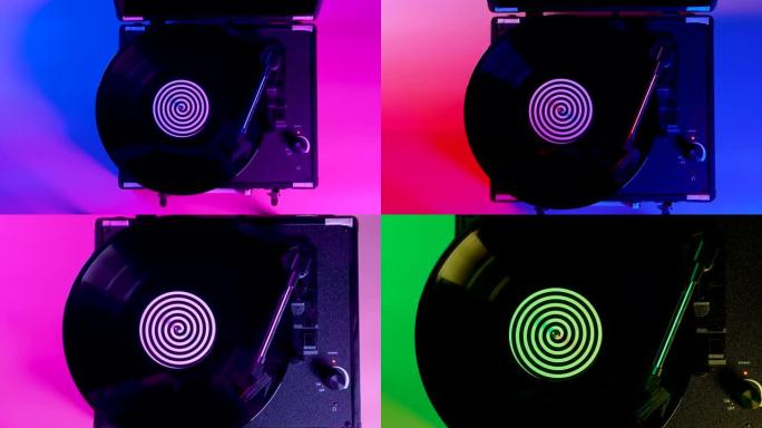 黑色黑胶唱片在dj转盘上旋转和播放音乐，盘子中央带有彩色标签。在明亮的霓虹灯光线中，乙烯基光盘的俯视