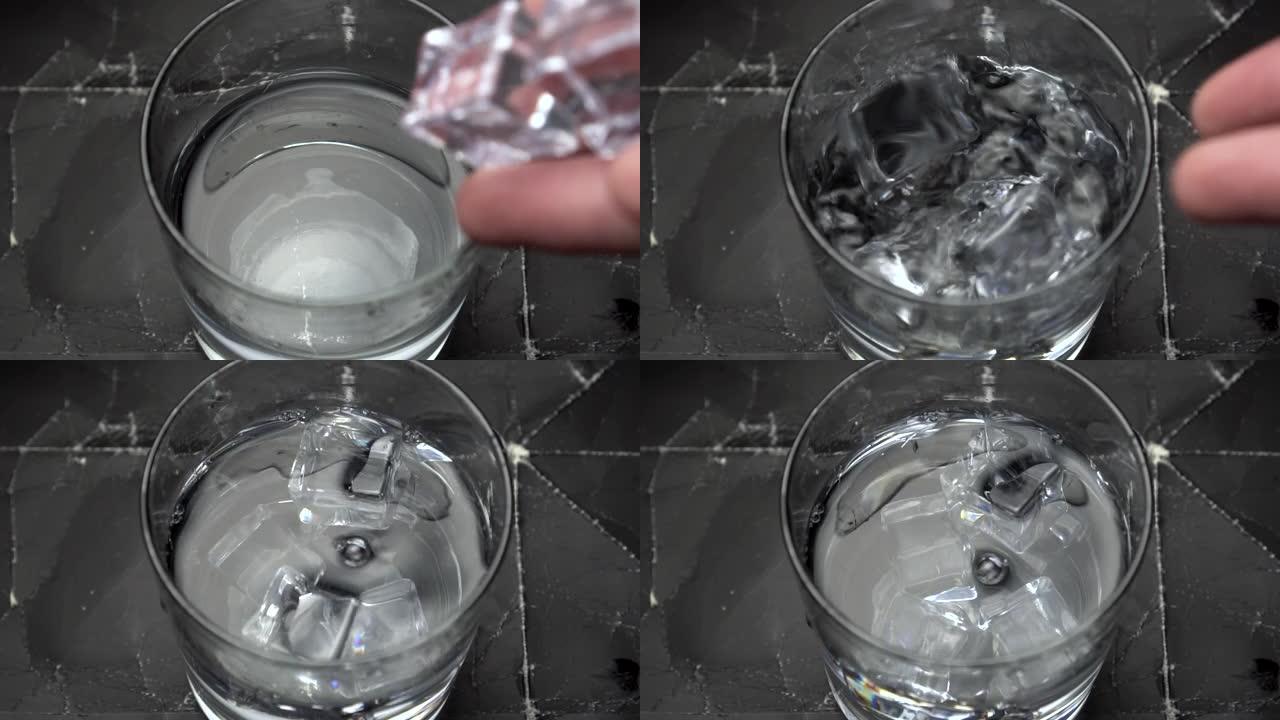 将冰块掉落到装有清水或酒精的玻璃杯中，并在玻璃杯中飞溅和旋转