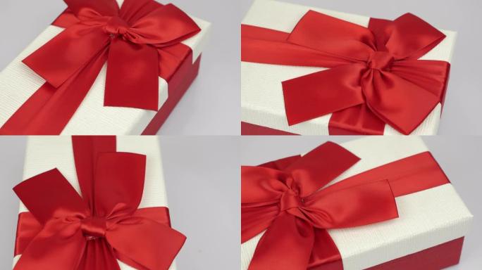 情人节假期惊喜。情人节礼物。带有红丝带蝴蝶结的白色礼品盒在白色背景下旋转。浪漫的问候。爱情和浪漫的概