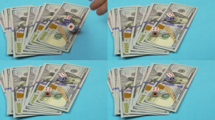 桌子上有100美元的钞票，手在上面扔骰子。