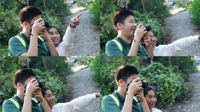 亚洲男孩和妹妹在森林里拍照，户外冒险概念。