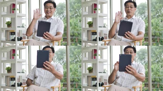 积极成熟的亚洲男人在家有视频通话。