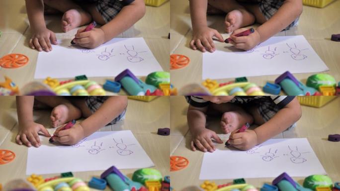 孩子用蜡笔在纸上画画或在家做作业的特写镜头
