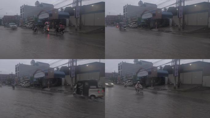 晚上下雨时，车辆穿过一条被水淹没的街道