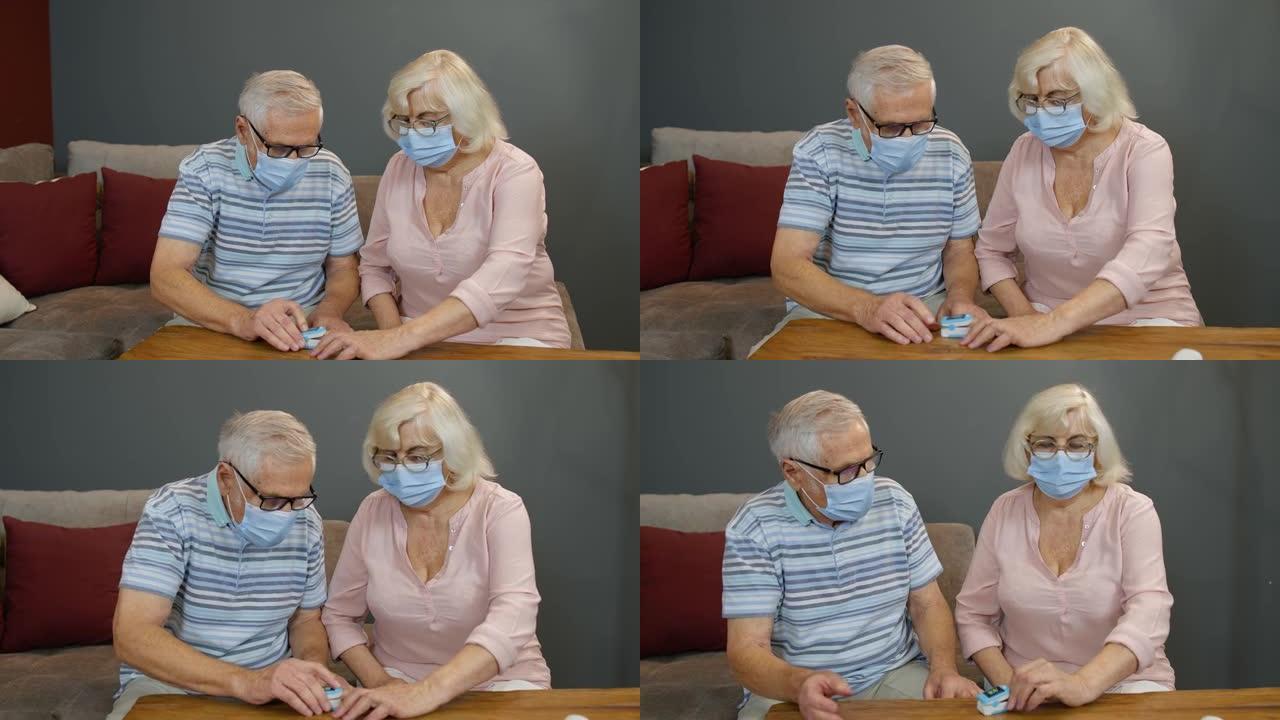 高级夫妇祖父和祖母用数字脉搏血氧仪监测氧饱和度