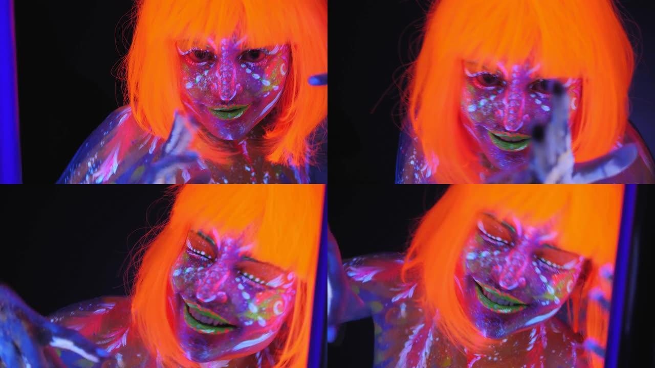 一个身上有紫外线图案戴着橙色假发在黑暗中跳舞的女人。