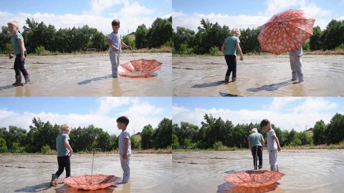 晴天，两个男孩在乡村道路上的大水坑里玩耍