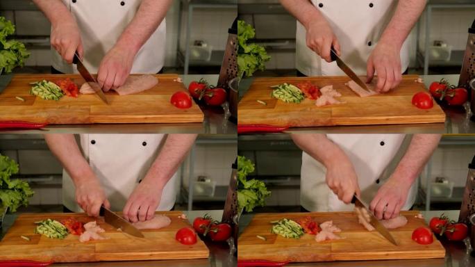 厨师在切菜板上切鸡肉和蔬菜的特写镜头。