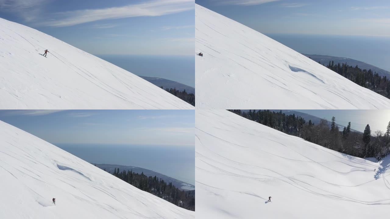 骑滑雪板的女孩在山坡上摔倒鸟瞰图
