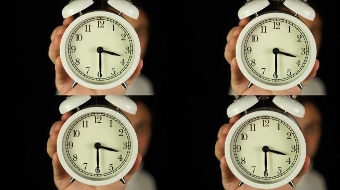 3:30点。人类手持闹钟，显示三点三十分的铃声。