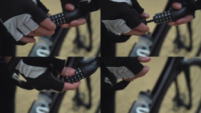 男性手在密码锁上拿起一个数字组合并打开它。自行车锁概念