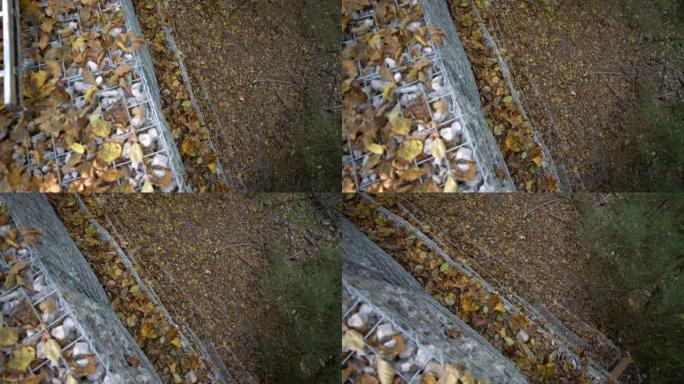 顶部特写镜头，秋天布满树叶的石笼