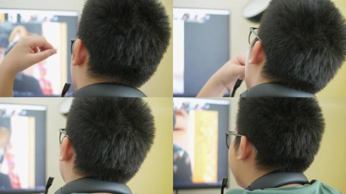快乐的亚洲男生戴着眼镜在家学习在线课程新型冠状病毒肺炎锁定，新的正常概念。