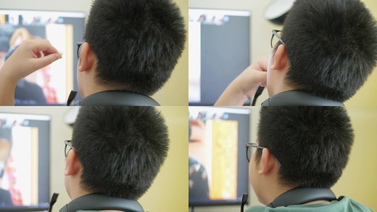 快乐的亚洲男生戴着眼镜在家学习在线课程新型冠状病毒肺炎锁定，新的正常概念。