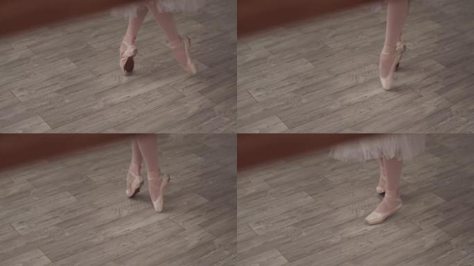 芭蕾舞女演员的脚在脚尖上的特写镜头，在上课前迈出脚步并伸展脚