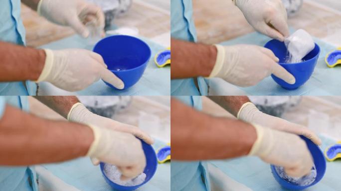 医生在正畸诊所揉捏石膏以制造人类颌骨。对准器的控制和诊断强制转换。