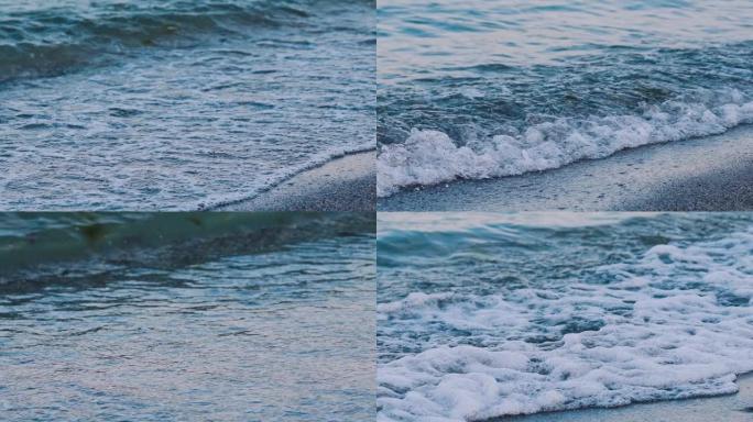 海边的海浪。令人惊叹的海水景色。海浪在卵石滩上撞击，形成白色泡沫。慢动作。