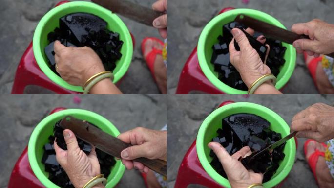 越南女人用刀切割黑草果冻，特写，越南