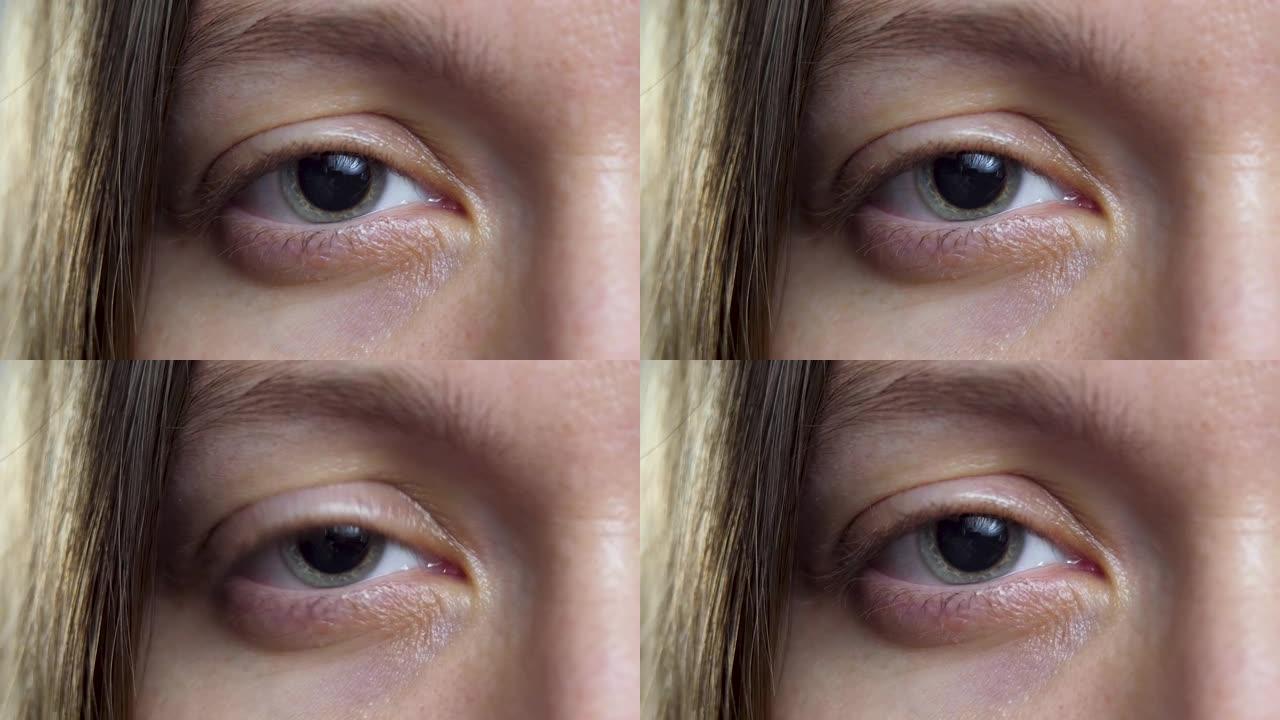 女性眼睛，瞳孔周围灰蓝色区域为虹膜