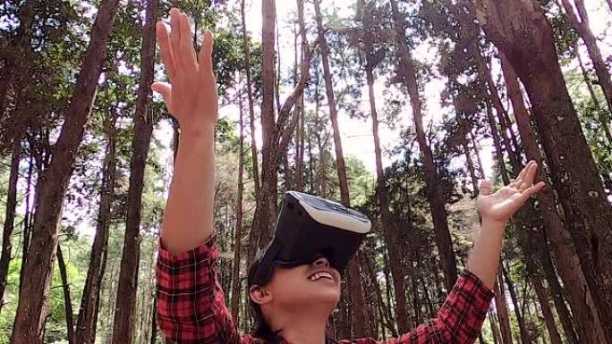 年轻的亚洲女性在户外公园享受虚拟现实护目镜。现代技术概念。