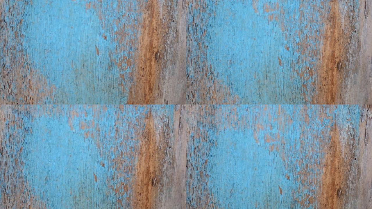 带有裂缝和污渍的旧木质绿松石破旧木板的质地。木制桌面的抽象背景