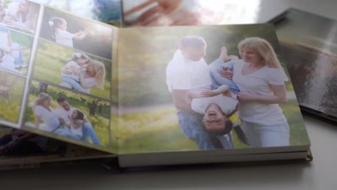 特写。一名妇女翻阅花园里家庭照片拍摄的相册。美丽方便的照片存储。重要时期的记忆。