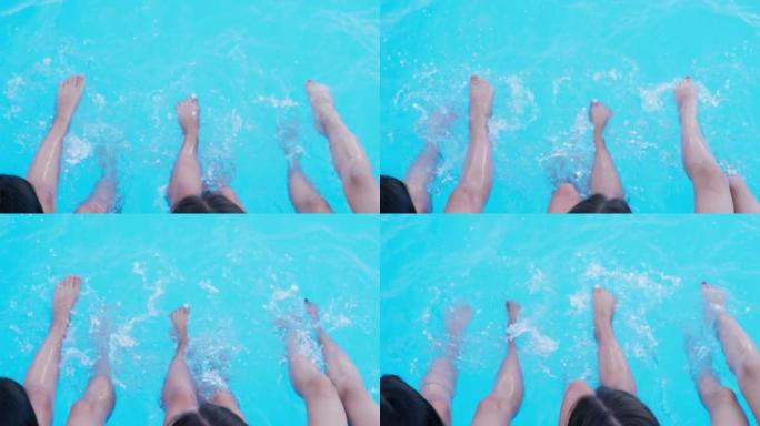 夏天休息，快乐美丽的女孩享受游泳池放松，在快乐的周末在水中放松双腿