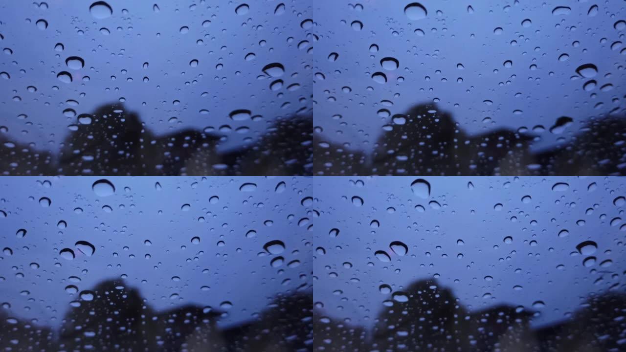 雨滴在挡风玻璃上，以自然为背景，看起来清新，为背景和文字。